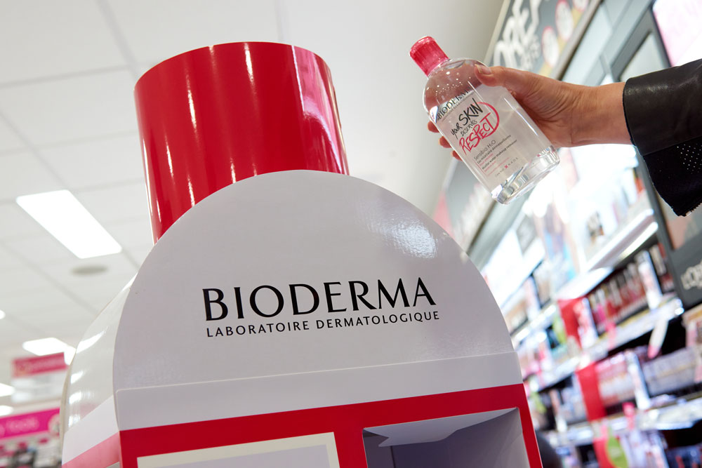 Bioderma product display stand with the featured product held up next to it