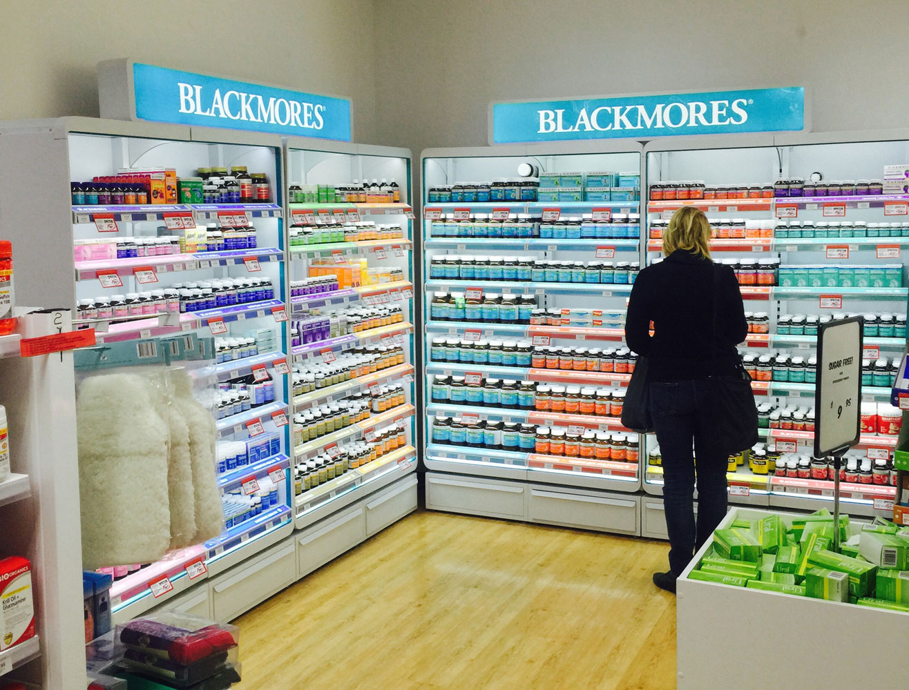 Blackmores retail product display with customer standing in front
