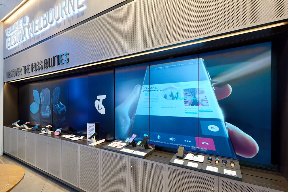 Samsung in-store display with screens behind products in Telstra store