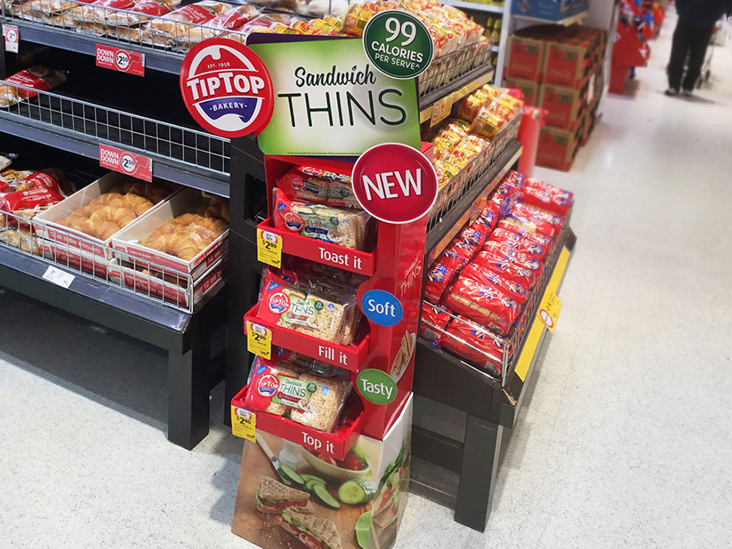 In-store Tip Top 'Sandwich Thins' product display stand in the bread and baked goods section of grocery store